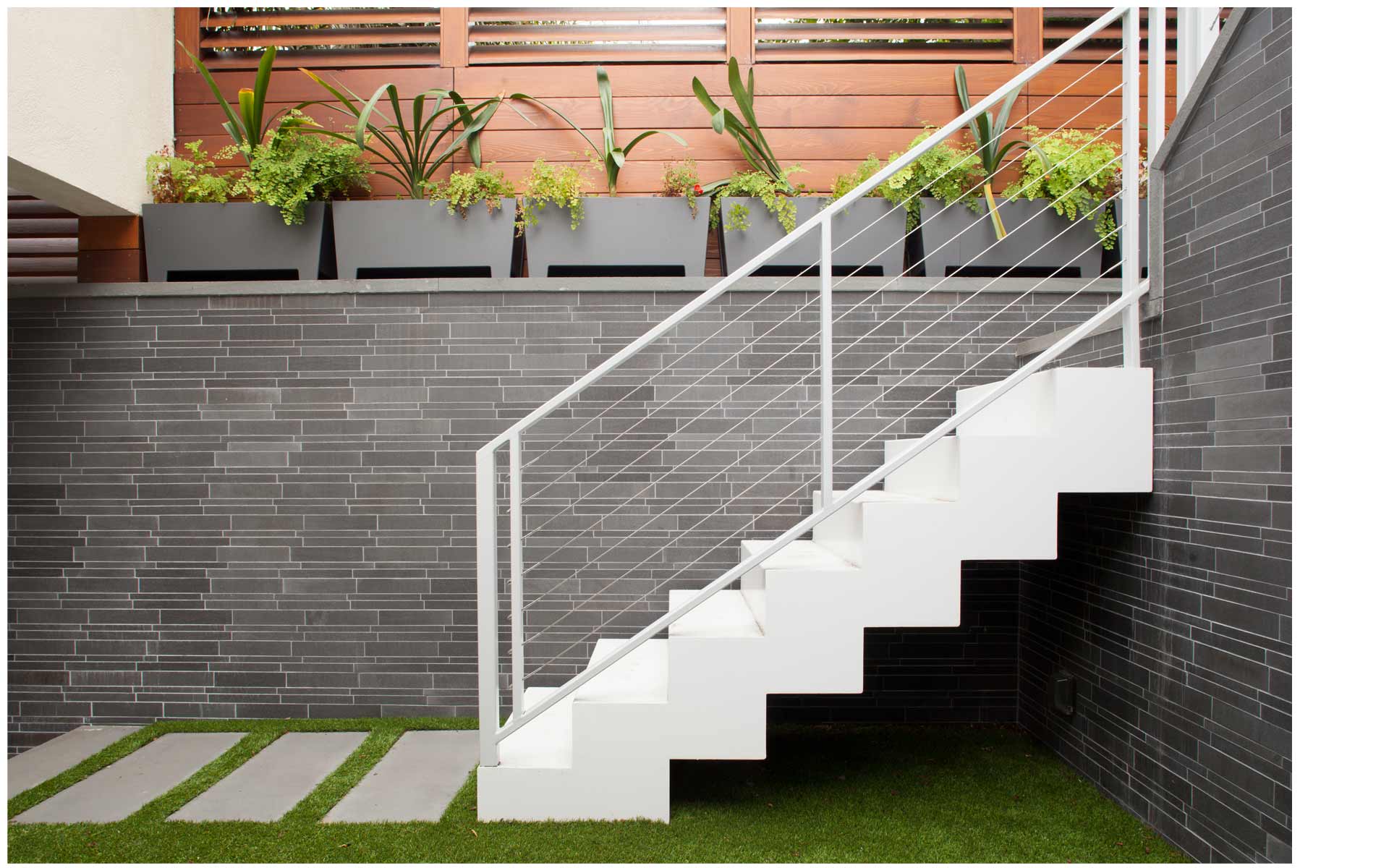 Norstone Grey Basalt Lynia Interlocking Tile Feature Wall in San Francisco Interior Courtyard showing tile pattern on wall